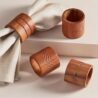 Wooden napkin rings with engraved geometric patterns for elegant table setting.