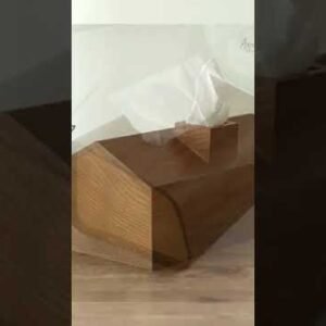 Wooden tissue dispenser for hotel or home decor, stylish and functional tissue holder.