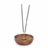 Wooden incense holder with black incense sticks for home decor.